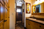 This charming bathroom features a spacious walk-in shower with elegant tile work and a frosted glass door.