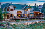 Experience luxury mountain living in this stunning custom-built home, featuring expansive decks and a covered patio perfect for entertaining.