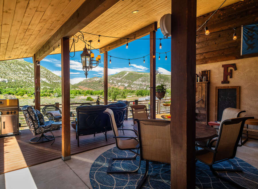 Enjoy breathtaking mountain views from this covered patio, perfect for outdoor entertaining.