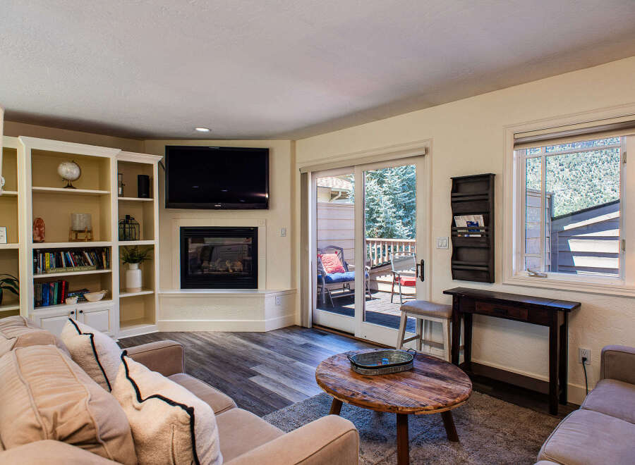 Cozy living room featuring a comfortable sectional sofa, a modern fireplace, and built-in shelving perfect for displaying decor.