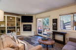Cozy living room featuring a comfortable sectional sofa, a modern fireplace, and built-in shelving perfect for displaying decor.