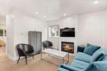 Cozy living room featuring a modern fireplace with a television mounted above.