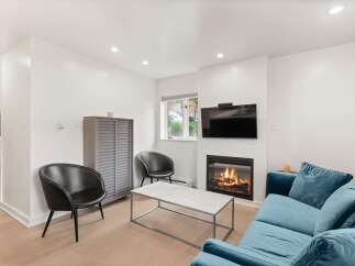 Cozy living room featuring a modern fireplace with a television mounted above.