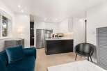 Experience modern living in this stylish studio apartment featuring a sleek, contemporary kitchen with high-gloss cabinetry and stainless steel appliances.