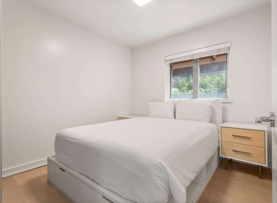 Discover comfort and style in this inviting bedroom, featuring a plush white duvet and two matching pillows for ultimate relaxation.