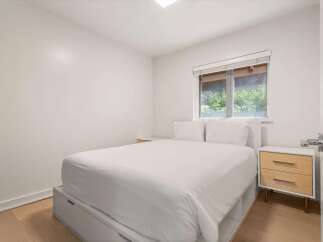 Discover comfort and style in this inviting bedroom, featuring a plush white duvet and two matching pillows for ultimate relaxation.