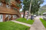 Discover this charming brick building featuring multi-level balconies with rich wooden railings, perfect for enjoying the mountain views.