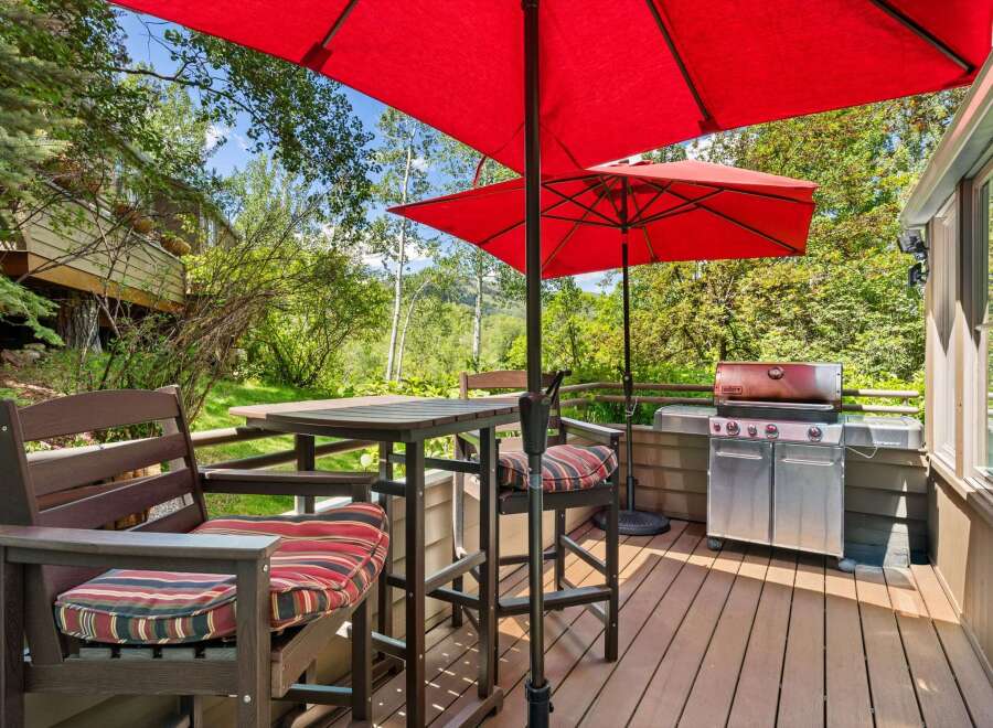 Enjoy outdoor living on this spacious deck, complete with a high-top table and chairs perfect for al fresco dining.