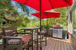 Enjoy outdoor living on this spacious deck, complete with a high-top table and chairs perfect for al fresco dining.