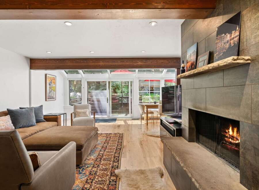 Experience cozy living in this inviting living room, featuring a warm fireplace and comfortable seating.