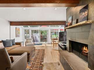 Experience cozy living in this inviting living room, featuring a warm fireplace and comfortable seating.