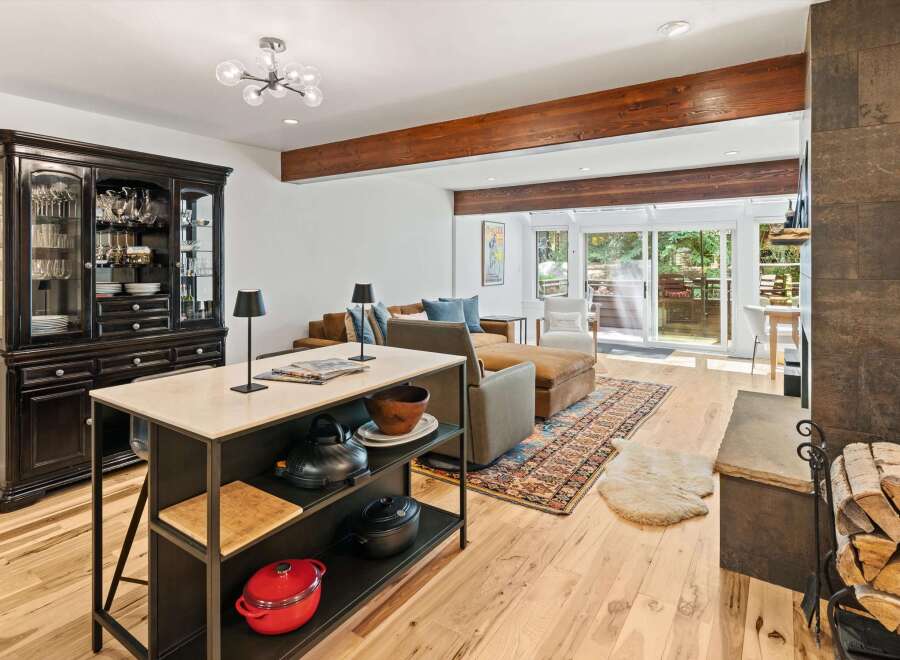 Experience open-concept living with this beautifully appointed space, featuring a modern kitchen island and a cozy living area.