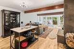 Experience open-concept living with this beautifully appointed space, featuring a modern kitchen island and a cozy living area.