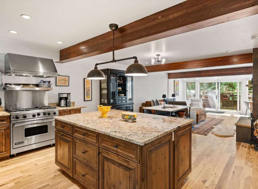 Experience luxury living in this stunning open-concept kitchen and living area, featuring a professional-grade Viking range and a spacious granite island perfect for entertaining.