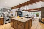Experience luxury living in this stunning open-concept kitchen and living area, featuring a professional-grade Viking range and a spacious granite island perfect for entertaining.