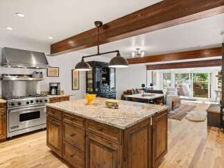 Experience luxury living in this stunning open-concept kitchen and living area, featuring a professional-grade Viking range and a spacious granite island perfect for entertaining.