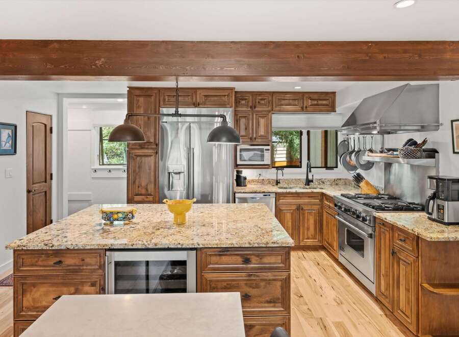 Experience luxury in this stunning kitchen featuring custom wood cabinetry and granite countertops.