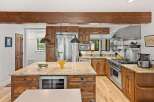 Experience luxury in this stunning kitchen featuring custom wood cabinetry and granite countertops.
