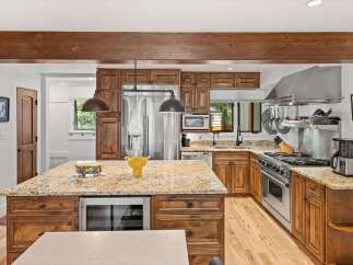 Experience luxury in this stunning kitchen featuring custom wood cabinetry and granite countertops.