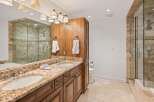 Experience luxury in this stunning bathroom featuring a spacious double vanity with granite countertops and ample storage.