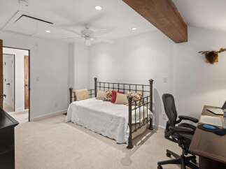 This charming room features a comfortable daybed adorned with decorative pillows, perfect for relaxation.