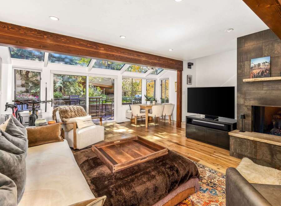 Experience luxurious living in this stunning home featuring a spacious living area with a cozy fireplace and a large flat-screen TV.