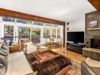 Experience luxurious living in this stunning home featuring a spacious living area with a cozy fireplace and a large flat-screen TV.