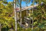 Nestled amidst vibrant autumn foliage, this charming home offers a serene retreat.
