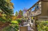 Enjoy the vibrant autumn colors surrounding this beautiful home, featuring a spacious deck perfect for outdoor entertaining.