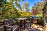 Enjoy outdoor living on this spacious deck, complete with a grill and dining set, perfect for entertaining.
