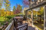 Enjoy the stunning autumn foliage from this beautiful deck, complete with a dining set and a grill.