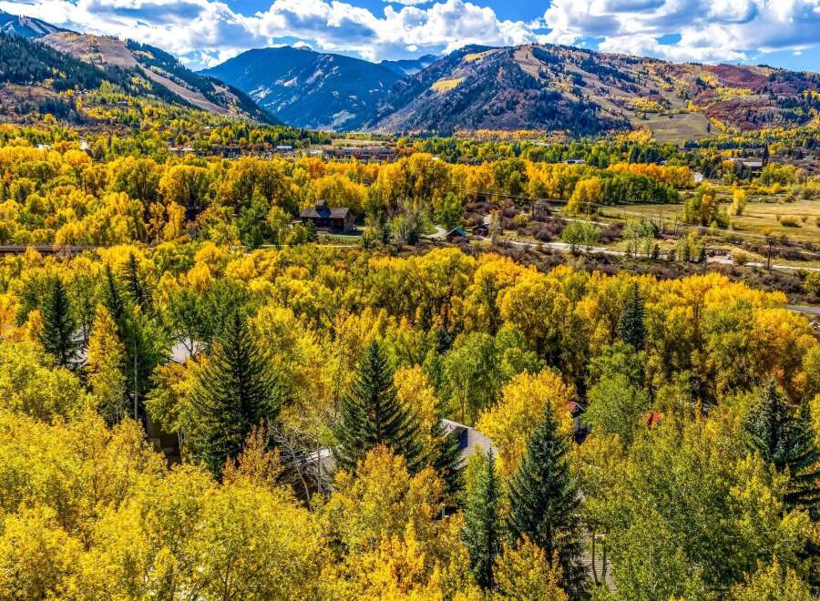 Experience the breathtaking beauty of autumn in this stunning mountain home, nestled amidst a vibrant tapestry of golden aspen trees.