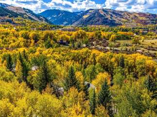 Experience the breathtaking beauty of autumn in this stunning mountain home, nestled amidst a vibrant tapestry of golden aspen trees.