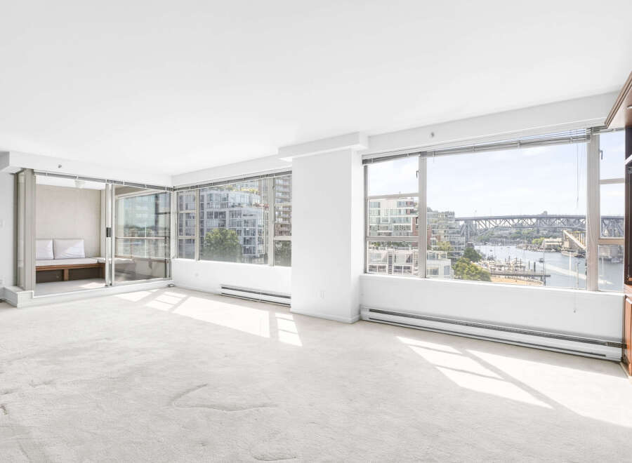 Experience breathtaking waterfront views from this spacious living area, featuring expansive windows that flood the room with natural light.