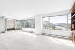 Experience breathtaking waterfront views from this spacious living area, featuring expansive windows that flood the room with natural light.