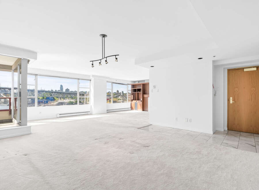 Experience breathtaking city and water views from this expansive living space, featuring floor-to-ceiling windows that flood the room with natural light.