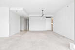 This spacious, unfurnished living area boasts a neutral color palette, making it a blank canvas for your personal style.