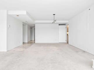 This spacious, unfurnished living area boasts a neutral color palette, making it a blank canvas for your personal style.