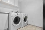 This laundry room features a stacked washer and dryer set, maximizing space and convenience.