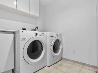 This laundry room features a stacked washer and dryer set, maximizing space and convenience.