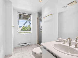 This bright and airy bathroom features a spacious vanity with a double sink and elegant brushed nickel fixtures.