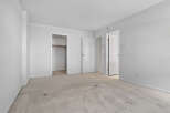 This spacious room features neutral carpeting and ample closet space, perfect for storage.