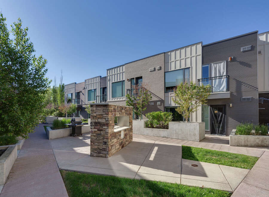 Experience modern urban living in this stunning townhouse complex, featuring sleek architecture and private balconies.
