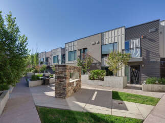 Experience modern urban living in this stunning townhouse complex, featuring sleek architecture and private balconies.