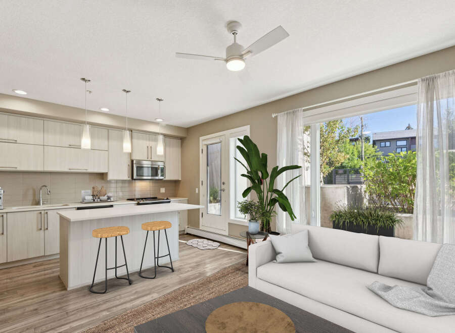 Discover modern living in this bright and airy open-concept space, featuring a sleek kitchen with a central island perfect for casual dining.