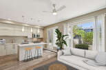Discover modern living in this bright and airy open-concept space, featuring a sleek kitchen with a central island perfect for casual dining.