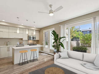 Discover modern living in this bright and airy open-concept space, featuring a sleek kitchen with a central island perfect for casual dining.