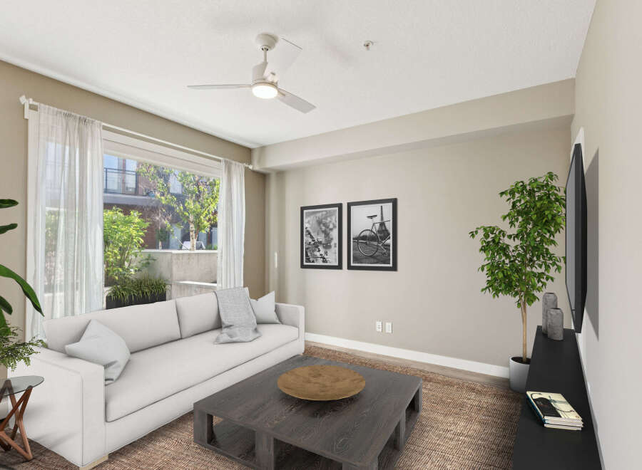 Experience modern living in this bright and airy living room, featuring a comfortable white sofa and a stylish dark wood coffee table.