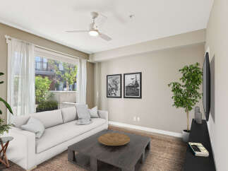Experience modern living in this bright and airy living room, featuring a comfortable white sofa and a stylish dark wood coffee table.