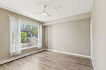 Bright and airy living space featuring a large window with sheer curtains, allowing natural light to flood the room.